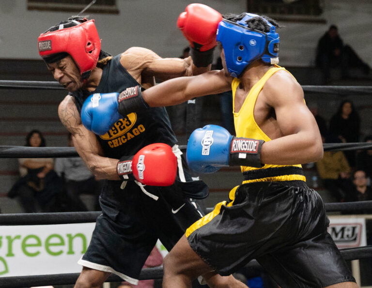 Zachary Carter punches his opponent with a hard right cross.